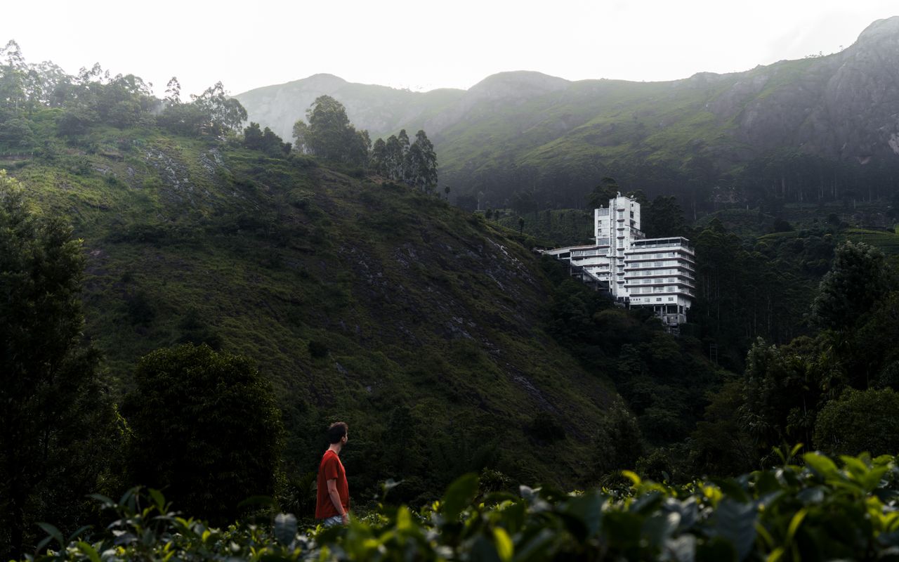 White hotel nestled in lush Indian mountains with a serene landscape
