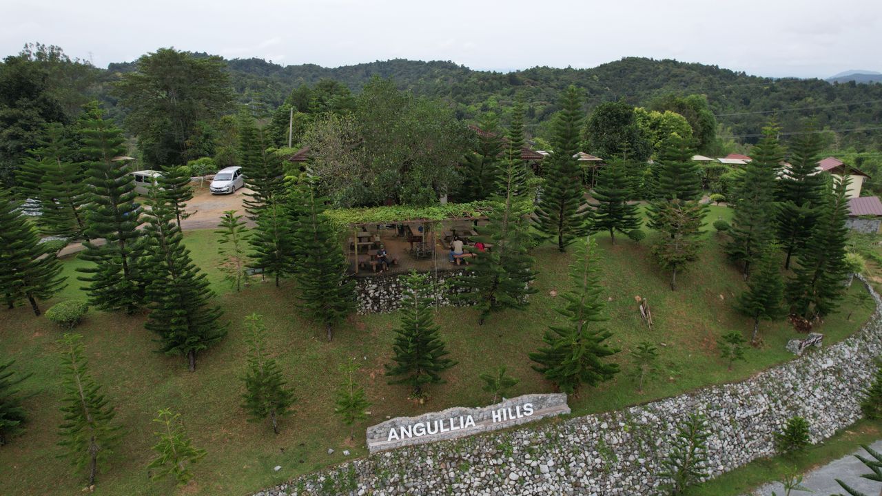 Scenic aerial shot of Angullia Hills surrounded by lush greenery in Malaysia.